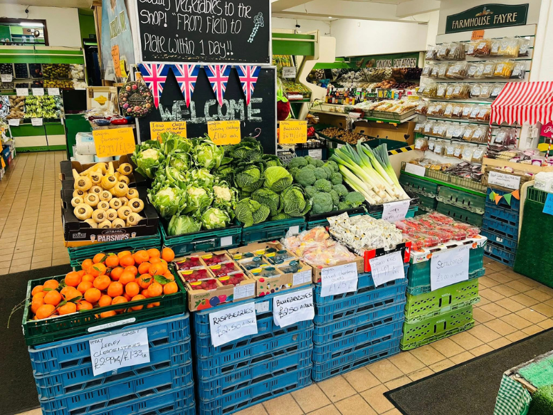 Fruit and vegetable containers showing a variety of produce inside a farm shop