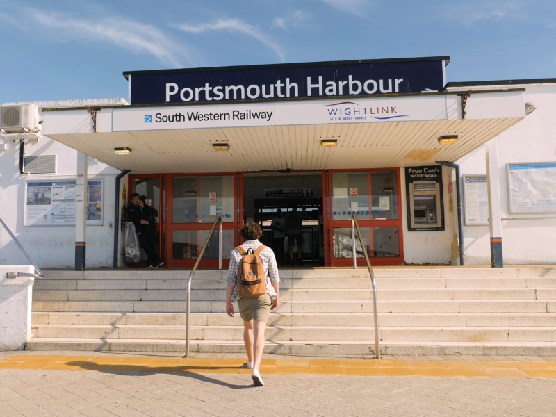 A man approaching Portsmouth Harbour Railway station on foot