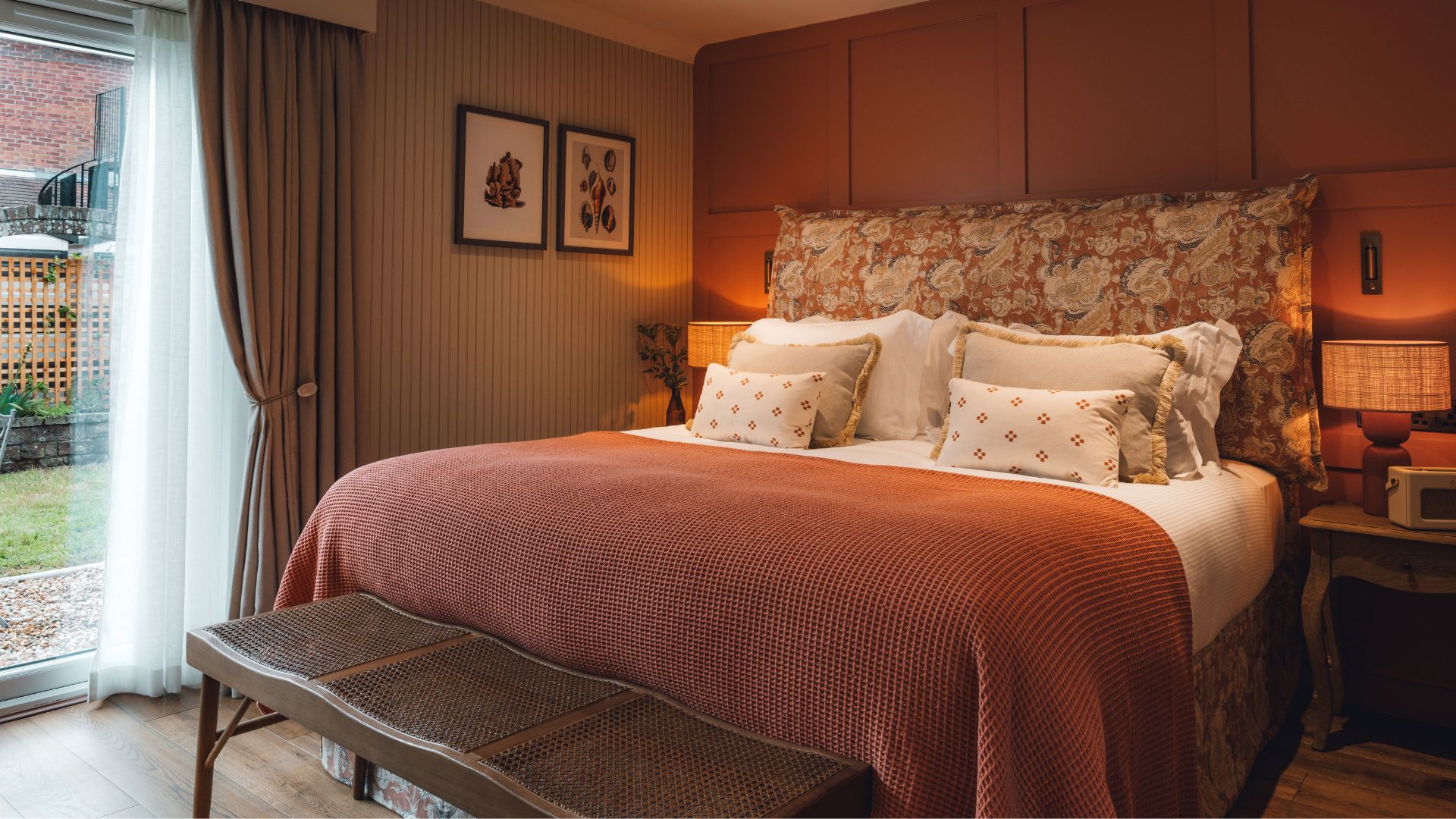 Comfortable bedroom at The Ropemaker with a large bed, patterned headboard and warm lighting.