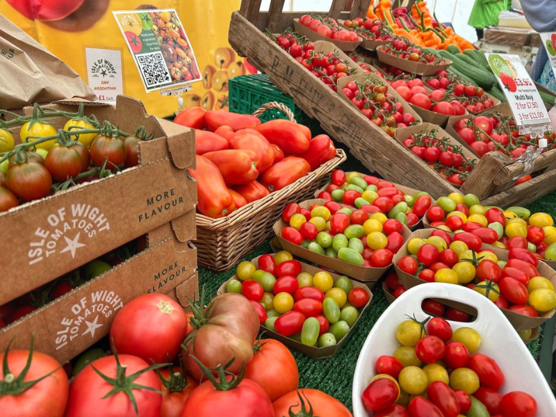 Punnets and crates of different coloured tomatoes