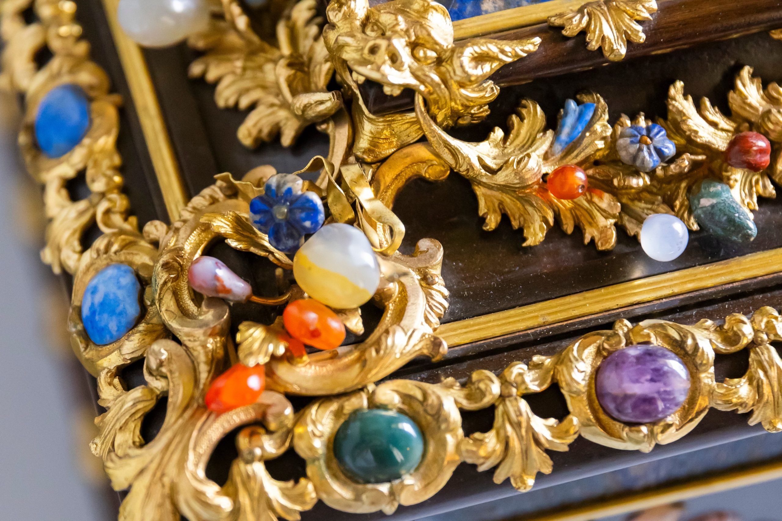 Close-up of an 18th-century Italian pietra dura casket with gilt detailing and colourful semi-precious stones at The Vyne.