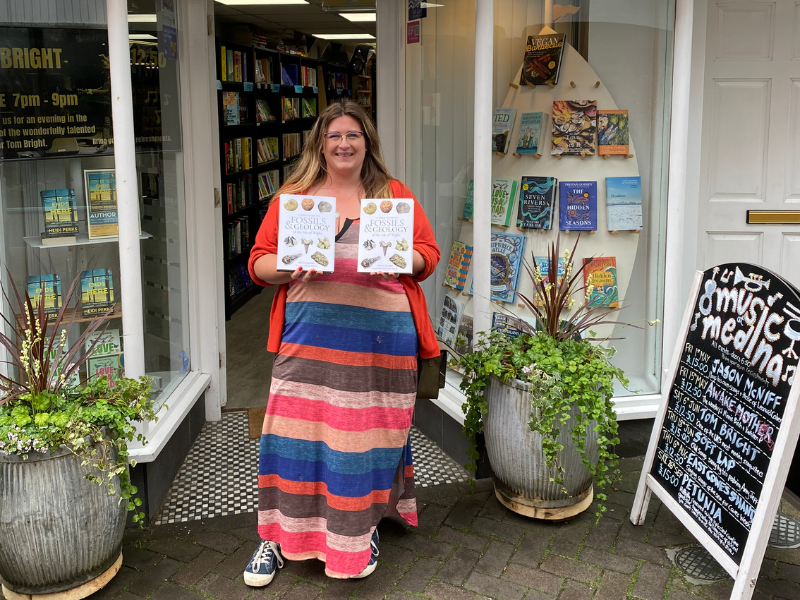 Author Megan Jacobs holds copies of her book outside a book shop on the Isle of Wight
