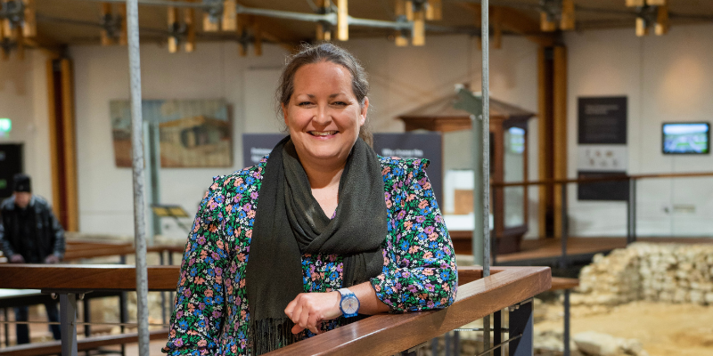 A woman inside a roman visitor attraction on the Isle of Wight
