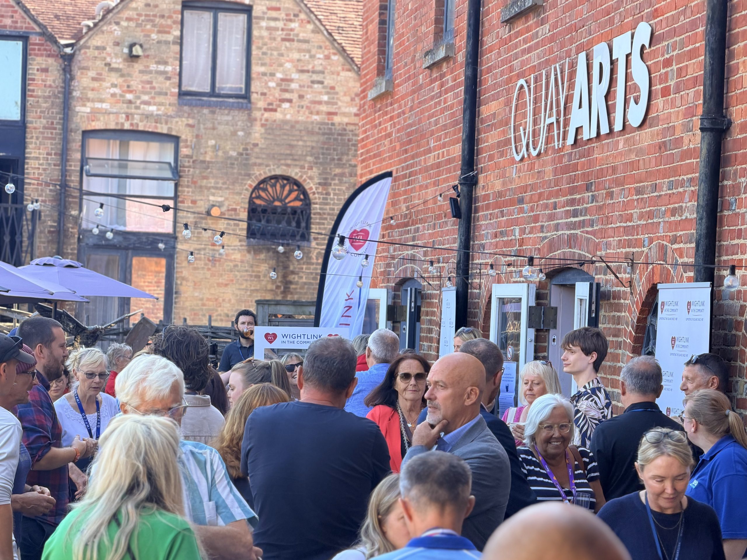 Community organisations, athletes and supporters networking outside Quay Arts during Wightlink’s annual Community celebration in Newport.