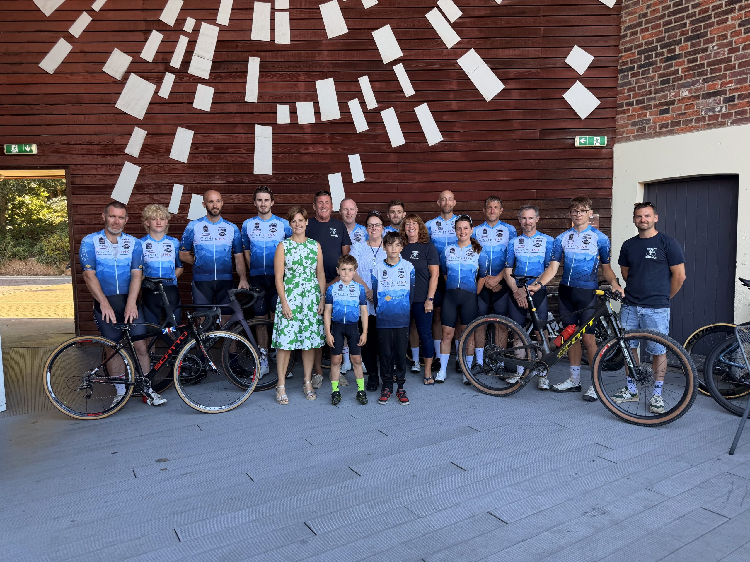 Group of cyclists and community representatives posing with bicycles at Quay Arts during Wightlink’s annual Community celebration event.