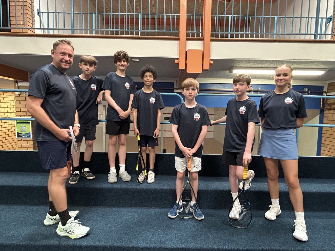 Isle of Wight junior squash players and their coach pose at Westridge Squash Courts during the inaugural IW Classic tournament.