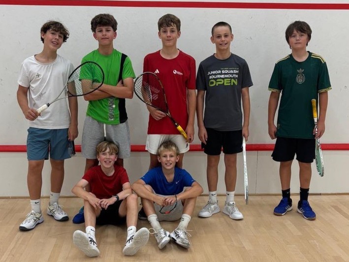 Junior squash players from Winchester Rackets and Fitness Club gather on court during the IW Classic squash tournament on the Isle of Wight.