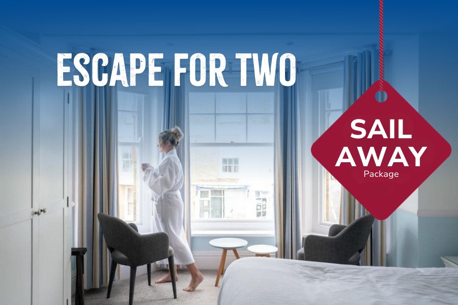 Hotel bedroom with large windows, armchairs and a neatly made bed, featuring a guest standing by the window in a bathrobe. Overlaid promotional text reads “Escape for Two”, alongside a red tag displaying “Sail Away Package”. The image promotes a relaxing short break combining ferry travel and hotel accommodation.
