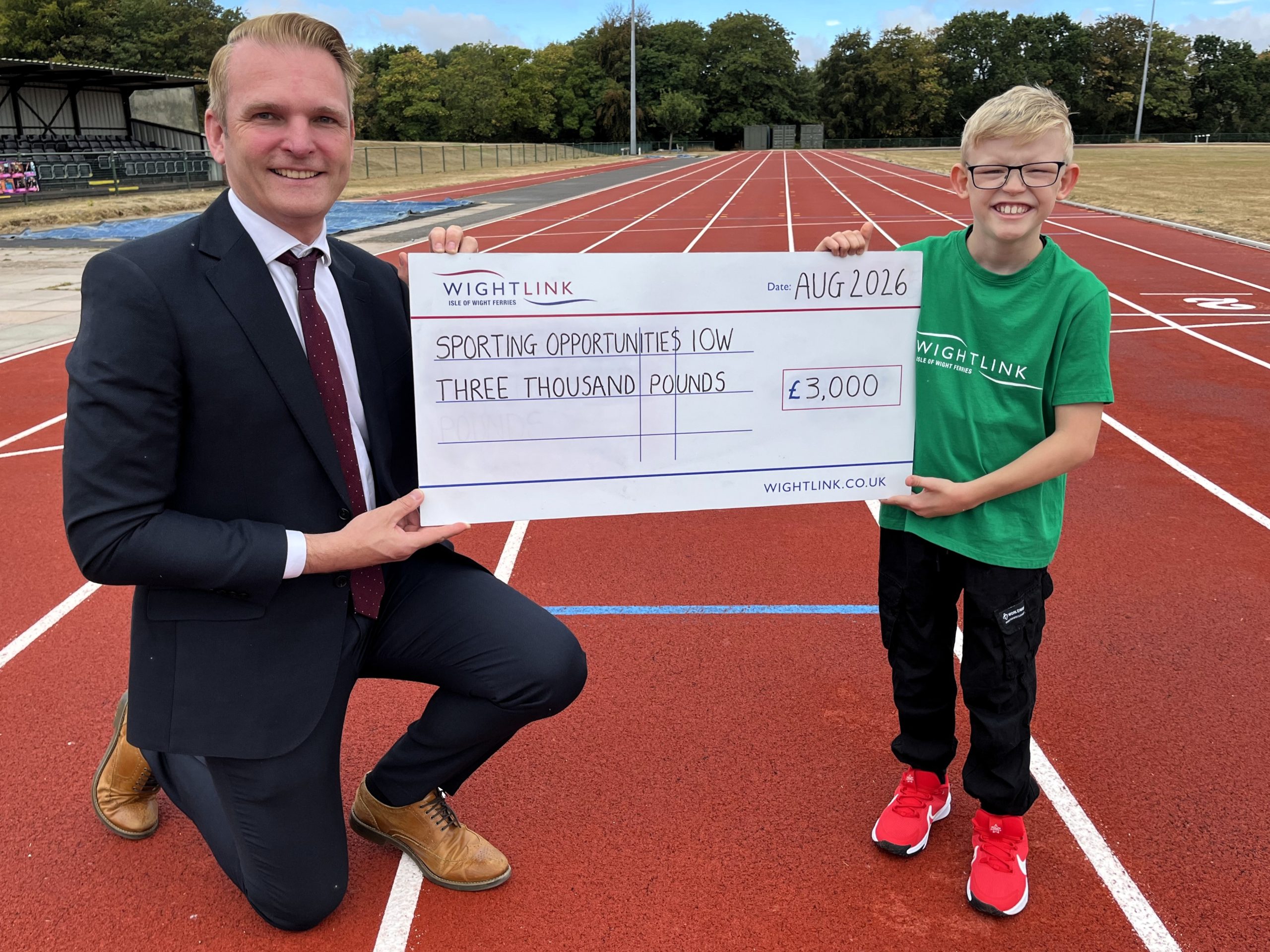 Wightlink presents a £3,000 cheque to Sporting Opportunities Isle of Wight to fund a bespoke Frame Runner for young athlete Jake Burton.