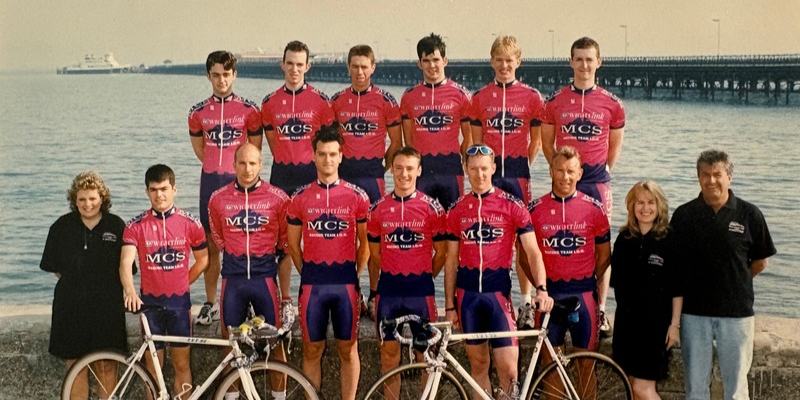A historic image of The Wightlink Cycle Race Team, lined up in Ryde against the sea wall with Ryde Pier in the background