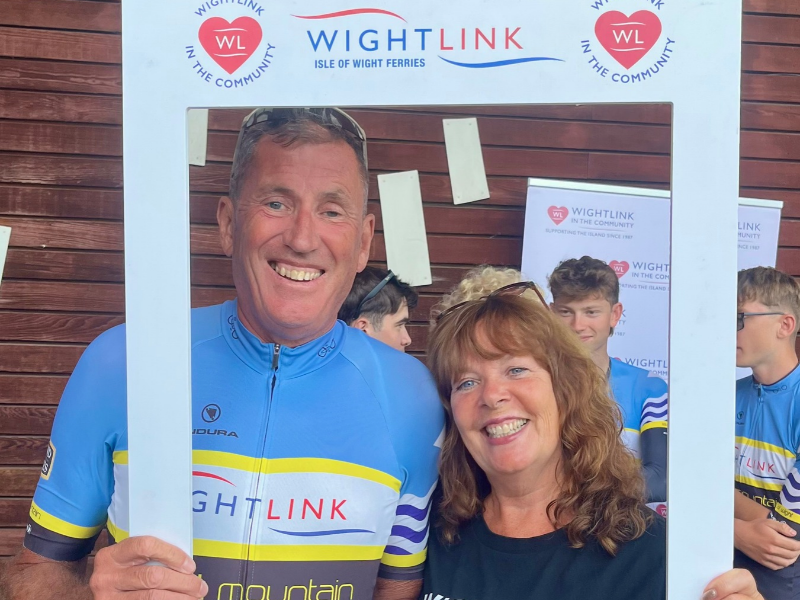Julie and Jerry Cooper, of Wightlink Cycle Race Team, pose inside a polaroid-style selfie board