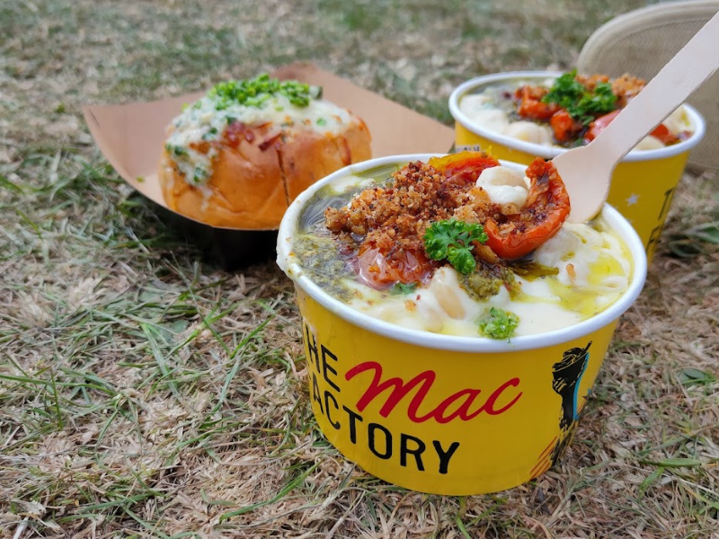 Takeaway street food - mac n cheese with garlic dome bread - okn the grass at a festival