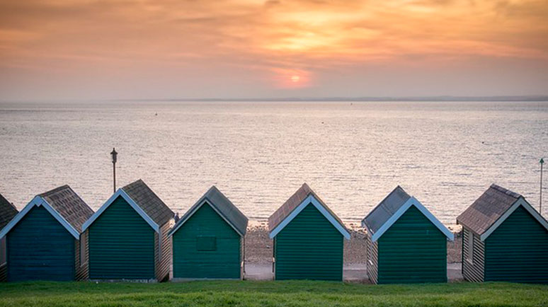 Gurnard Beach sunset and beach huts, Isle of Wight