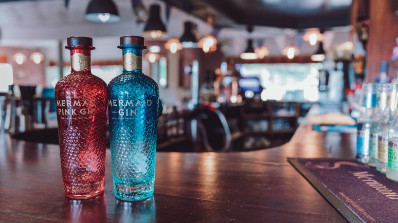 Two bottles of Mermaid Gin on a bar at the distillery, Isle of Wight