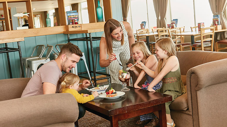 A family inside the Nodes Point Holiday Park restaurant